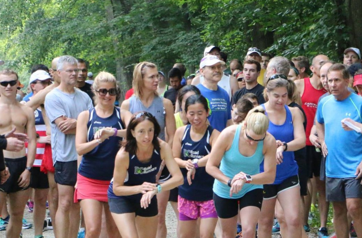 A group of runners are about to take off for a race.