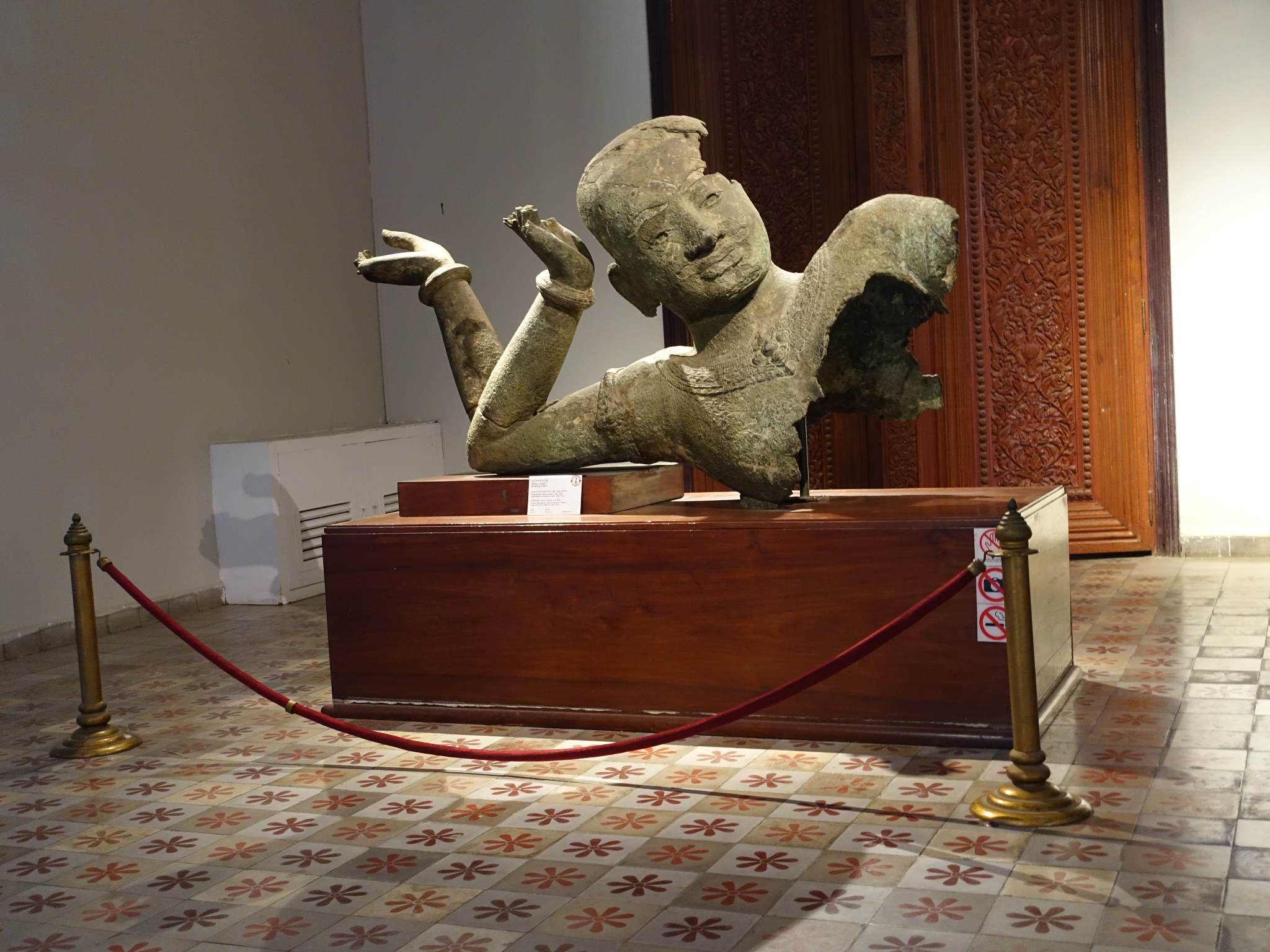 A bronze statue of reclining Vishnu at a museum