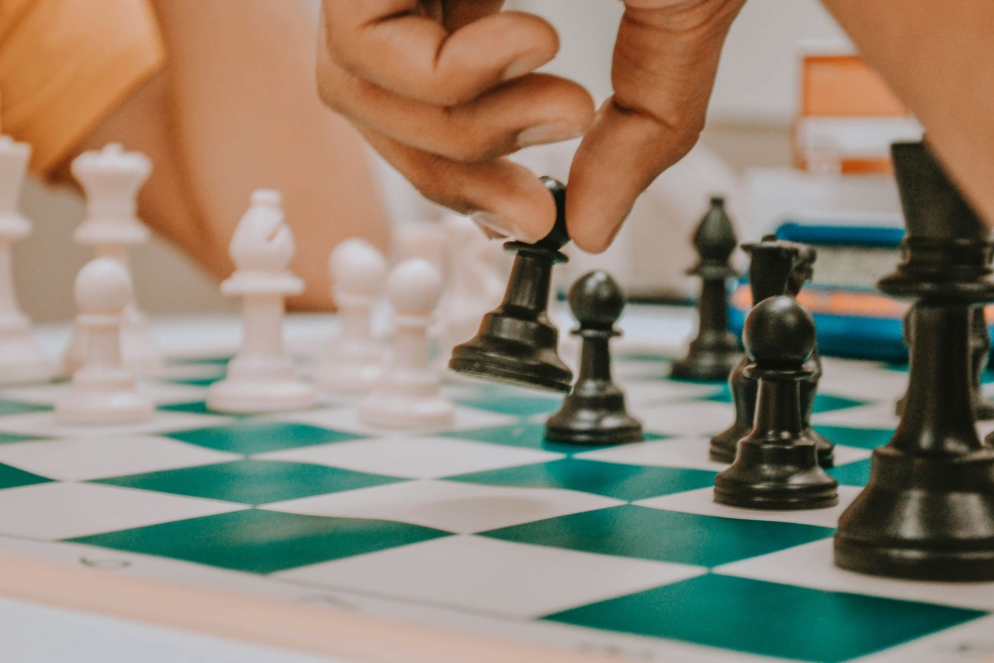 A close-up photo of two people playing chess