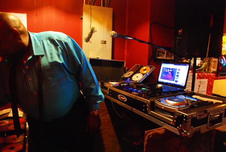  A person DJ's in a dark room