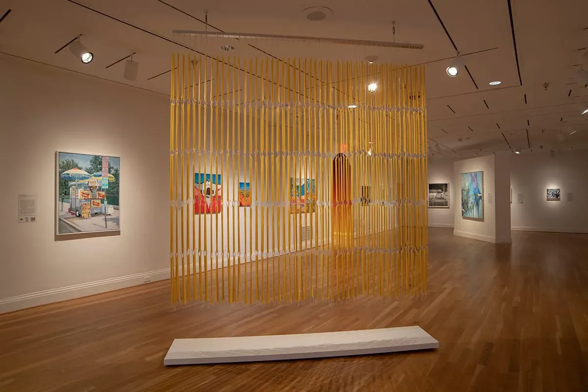 A bright-yellow sculpture, made in beeswax by D.C. artist Mary Early, hangs from a gallery ceiling at the Phillips Collection.