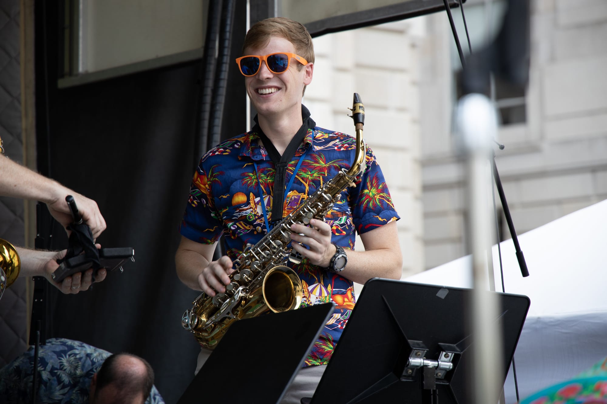 A saxophonist in a Hawaiian shirt on stage.