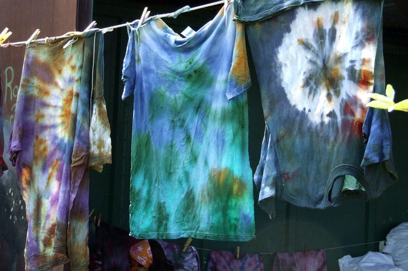 Tie-dyed clothing on a clothing line.