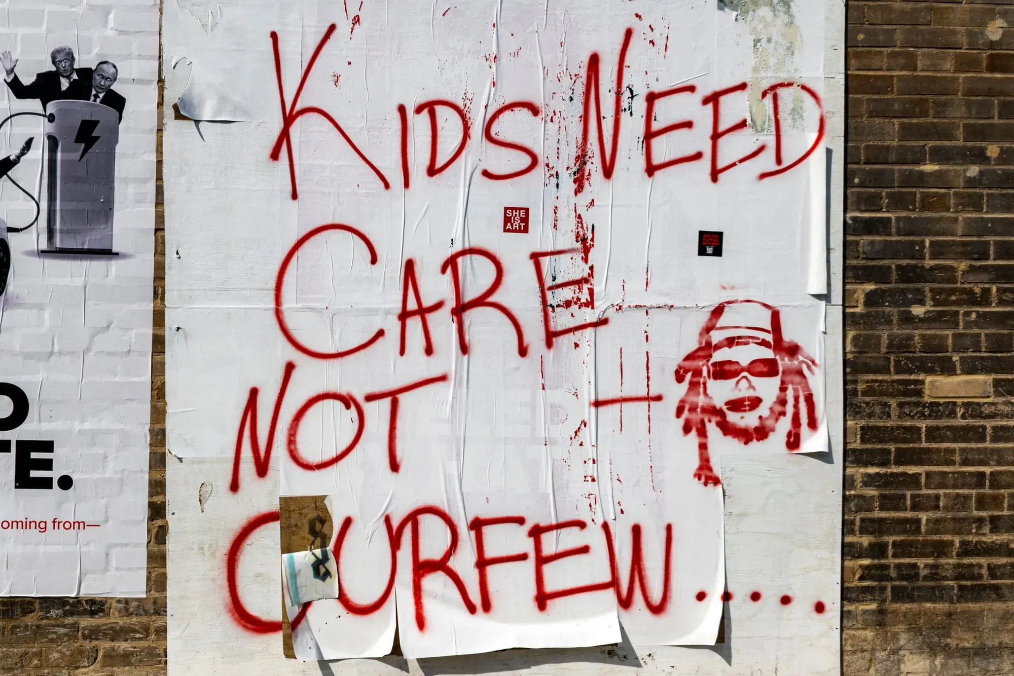 A photo of a sign that says "Kids need care not curfew."