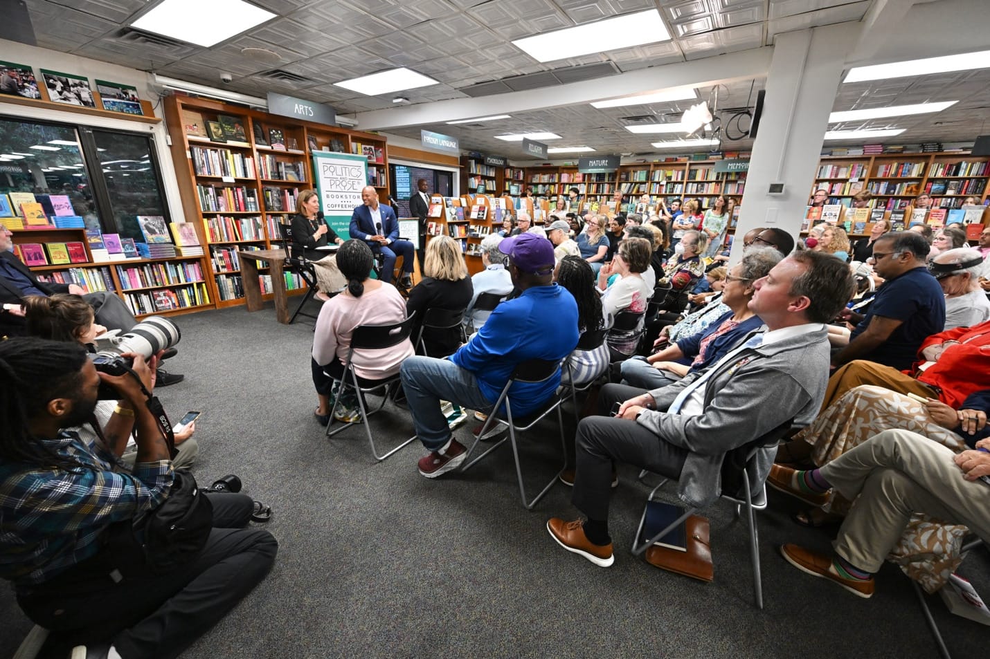 People attend an event at D.C.'s Politics and Prose bookstore.