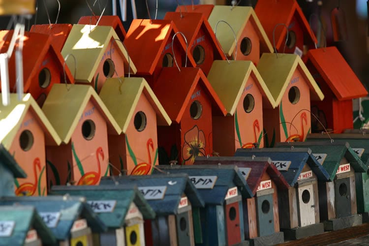 A row of painted birdhouses.