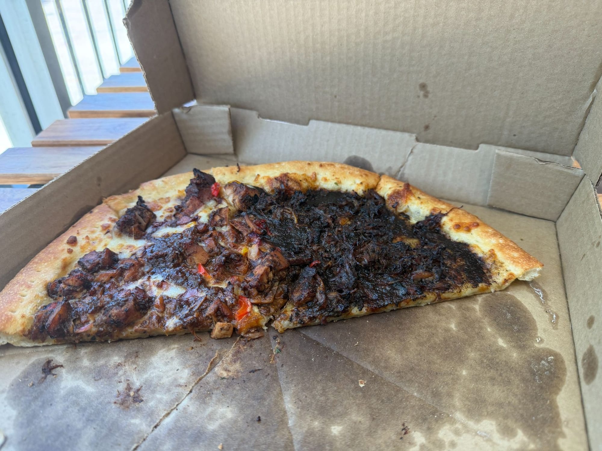 A half jerk chicken, half oxtail pizza.