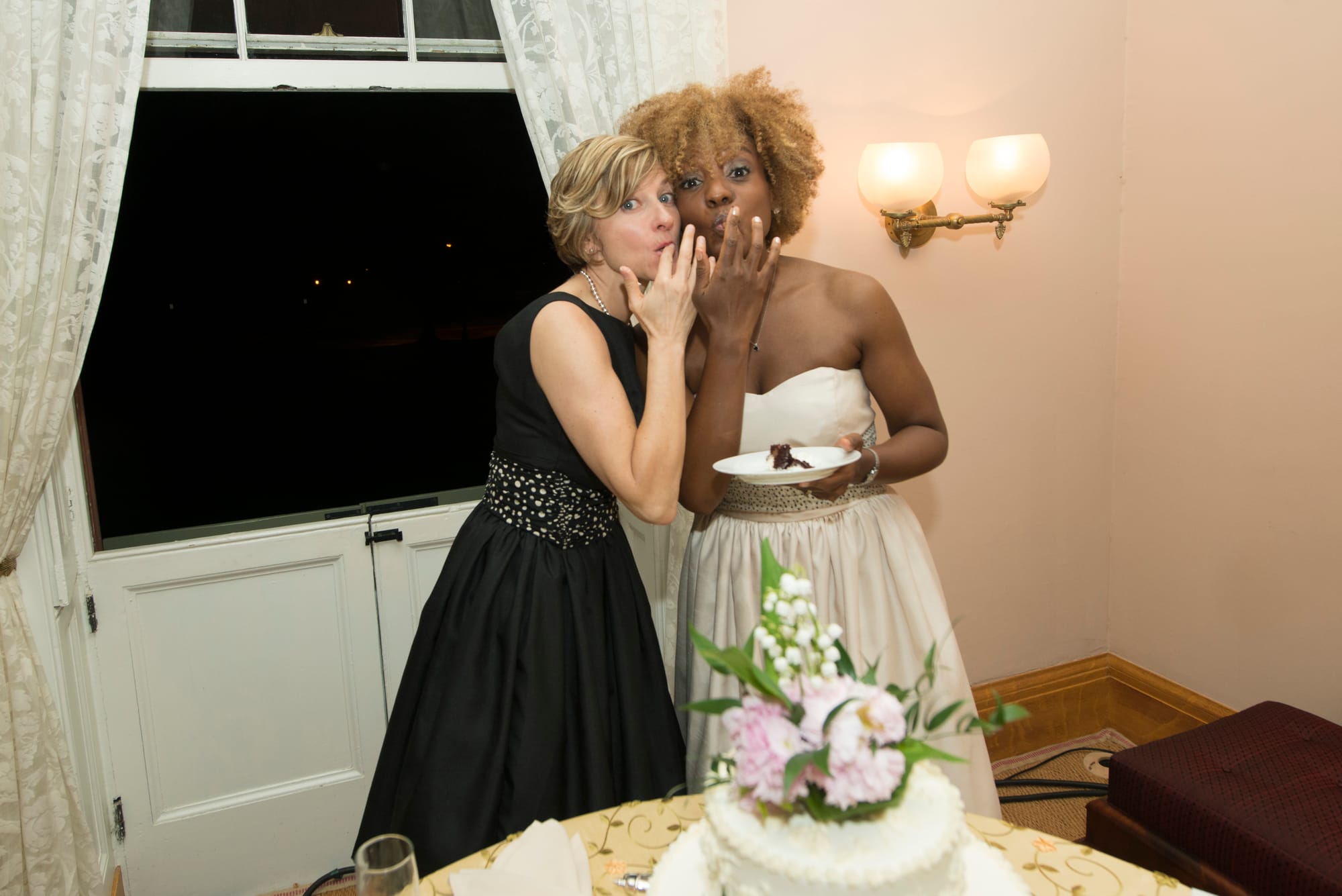 Durrett and her wife, Erin, sharing a bite of cake on their wedding day at President Lincoln's Cottage in Petworth.