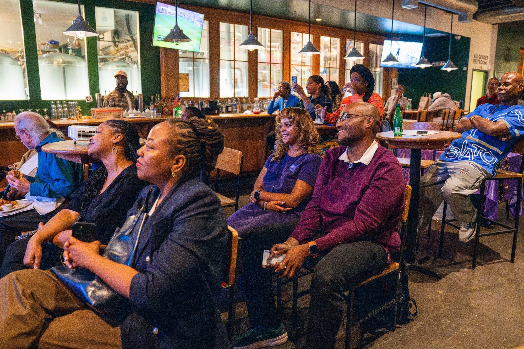 People watch a documentary screening at Urban Garden Brewing.