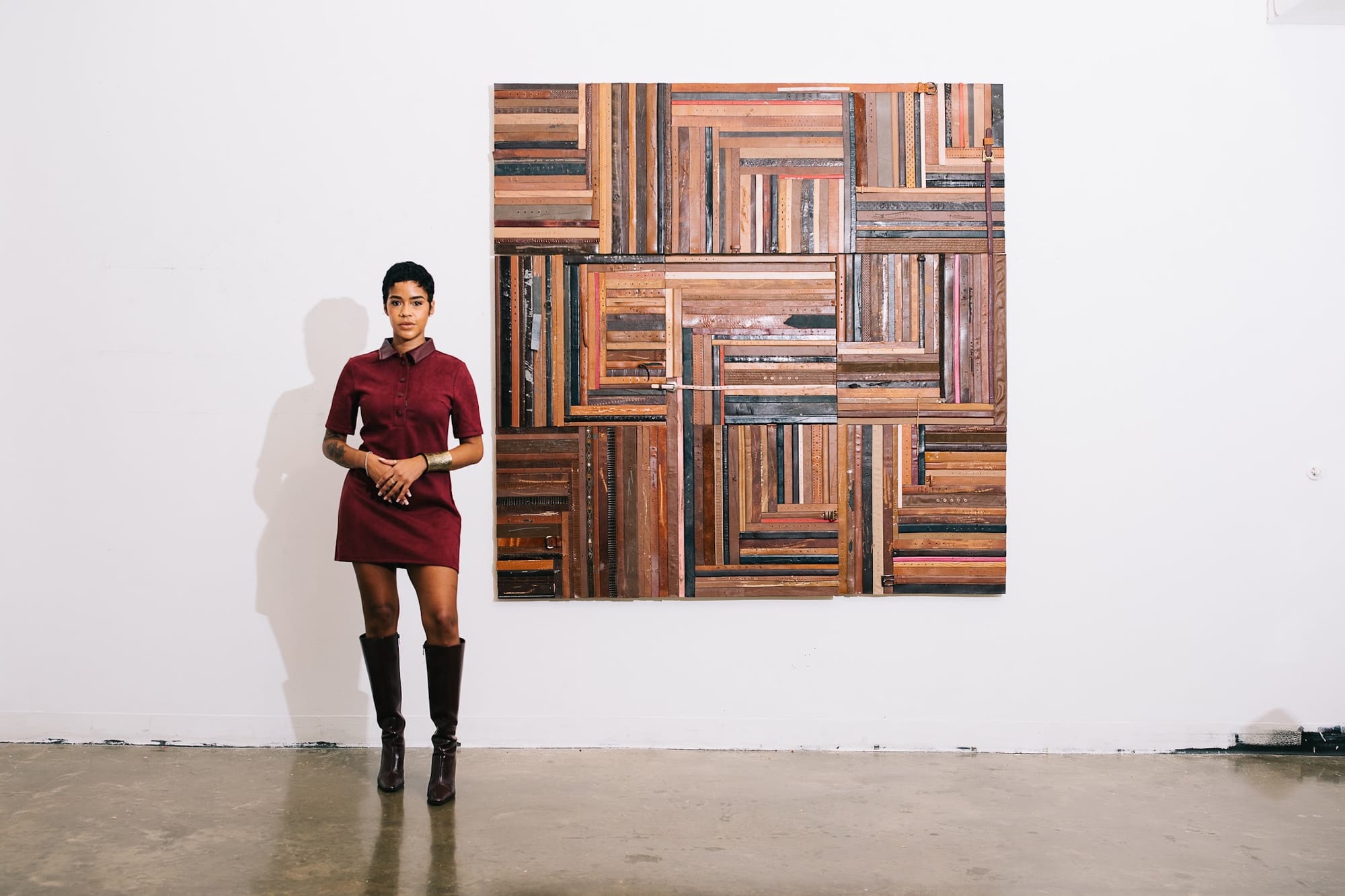 A portrait of artist Lex Marie with one of her pieces.