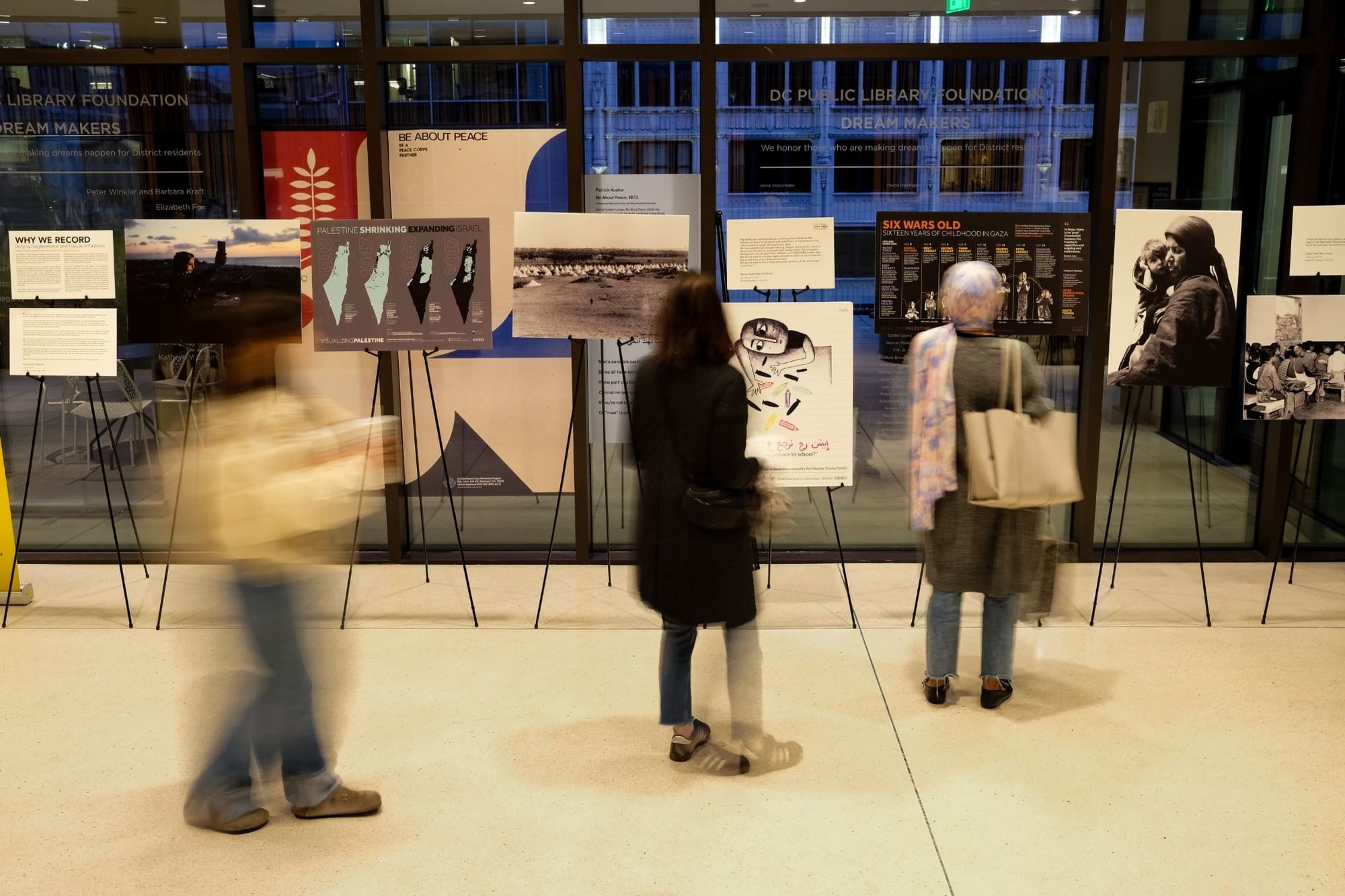 People mill around looking at work at the Palestinian Film & Arts Festival