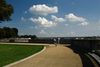 A cyclist in the middle of a bike path near the Potomac river on a sunny day with blue skies in the background.