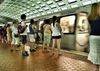 People wait for Metro train to stop.