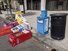 Colorful newspaper boxes in various states of knocked over along a sidewalk in D.C. 