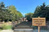 A photograph of the empty Meridian Hill Park fountain with a fake sign on the image reading: "Trump repairs coming soon! (Maybe)"