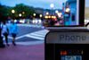 A phone booth with a book resting on top at dusk in Mount Pleasant, D.C.