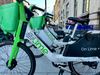 Lime bikes wait for riders on a D.C. sidewalk.