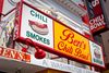 The outside of Ben's Chili Bowl. A sign with the restaurant's name and "Chili," "Smokes," and "Burger."