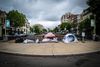 Three tents in D.C.'s Dupont Circle under a cloudy sky.