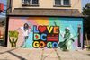 Mural that says Love DC Go-Go with a man dancing. 