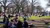 A photo of hundreds of people on the grass of Malcolm X Park. 