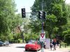 An image of a traffic light with pedestrians in the background and signs to yield to pedestrians 