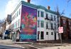 A mural on a corner in D.C. that reads "Somos DR DC"
