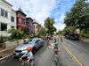 An all-ages group bike ride passes rowhouses in Washington, D.C.