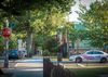 A photo of a D.C. neighborhood street with a police car parked at an intersection