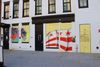 A mural of a D.C. flag painted over a boarded up door