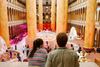 A photo of two people in the foreground of the National Building Museum's atrium.