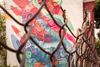 A photo of a mural from behind a fence.