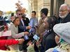 Trayon White is seen in a circle of reporters outside the federal courthouse in 2024.
