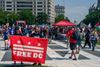 A Free DC banner being held up. 