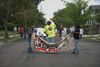 A group of tenants march down the street with a sign that reads "Stop Subsidizing Slumlords."