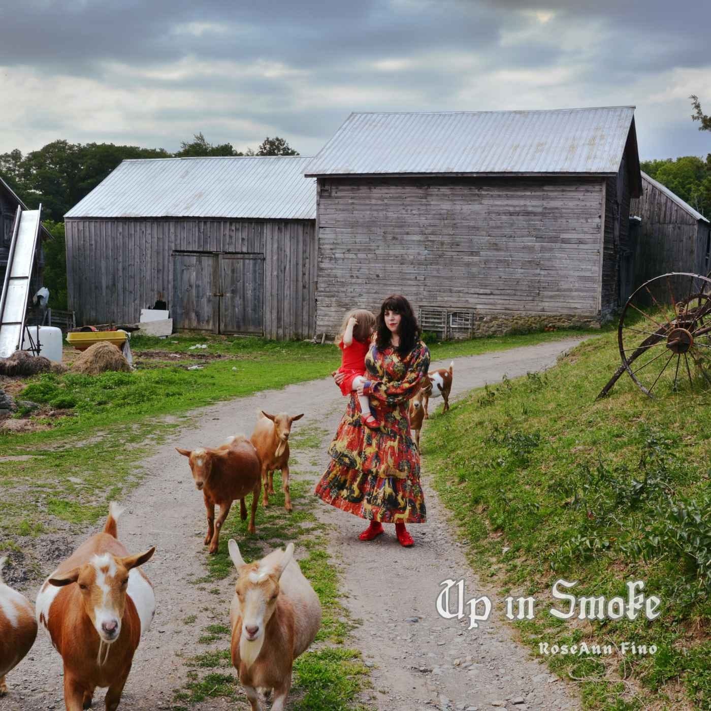 A person and a child walking on a dirt path with goats

Description automatically generated