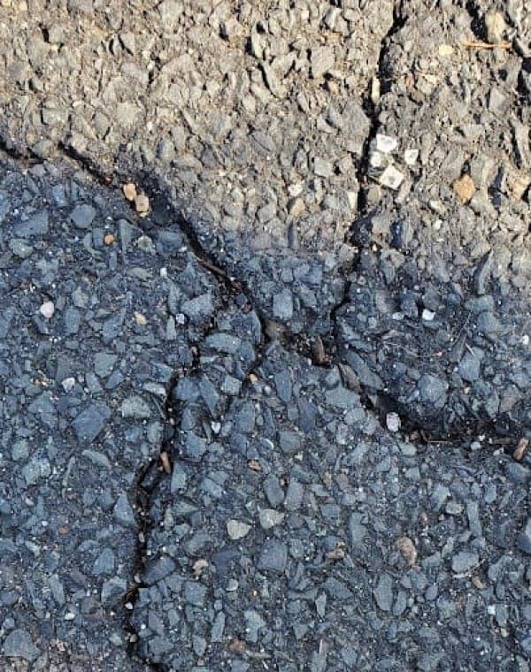 A Hebrew letter aleph made out of cracks in the pavement.