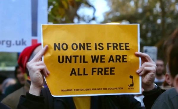 Sign: NO ONE IS FREE UNTIL WE ARE ALL FREE
