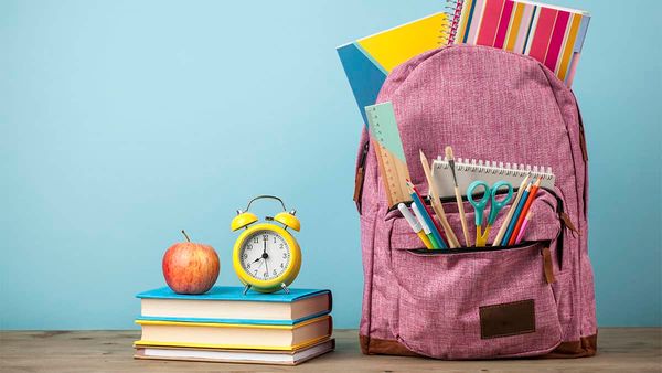 Working to stuff backpacks for students back to school