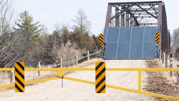 Residents decry installation of large steel barricades on Peel Street bridge