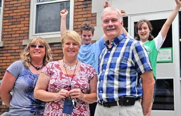 The St. Jacobs Optimist Club is giving $10,000 to leadership programs and counselling services for St. Jacobs Public School students. From left, Optimist member Heather Weber, student Patrick Perry, Principal Kathy Mathers, student Rebecca Perry, and Optimist member Bob Wilbur.[Whitney Neilson / The Observer]