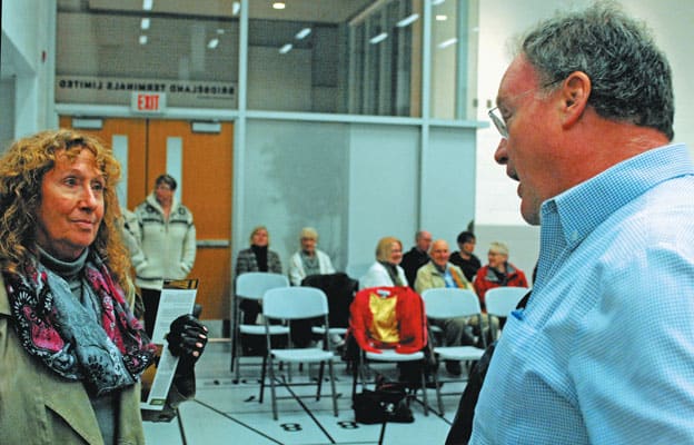 Ward 1 candidate Sebastian Siebel-Achenbach speaks with resident Brenda Kempel, who pressed for a format change to allow for a proper public forum at Tuesday night's event in Elmira.[Steve Kannon / The Observer]