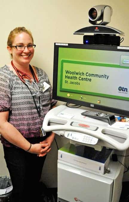 Woolwich Community Health Centre telemedicine nurse Jenn DeCosta uses a video conferencing unit to connect patients with health care professionals from around the province. [Scott Barber / The Observer]