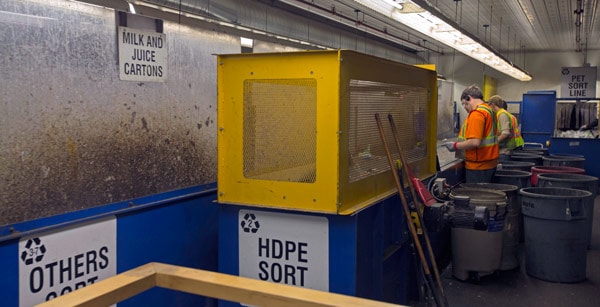 Employees for a private company sort the recyclables into three categories.[Tristan Urry / The Observer]