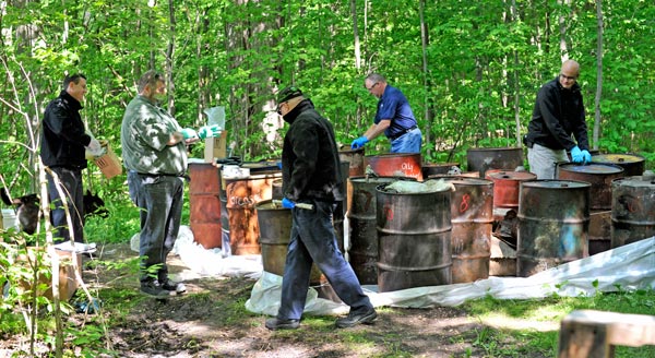 Safety-Kleen and Waste Management have teamed up to dispose of the two dozen barrels of hazardous waste illegally dumped in the sugar bush at 1189 Weeby Pl. near Conestogo last month.   [Scott Barber / The Observer]