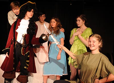 Ben Martin as Michael, Simon Zenker as John, Maddie McCormick as Wendy and Krista Quinn as Tinkerbell look on as Captain Hook (Jared Wallis) and Peter Pan (Hadley Moustakas) fight for Neverland in EDSS’ production of Peter and Wendy.[Liz Bevan / The Observer]