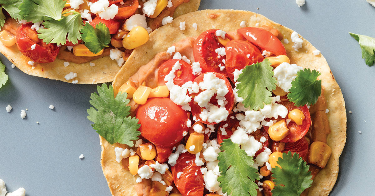 Crispy tostadas topped with beans and veggies