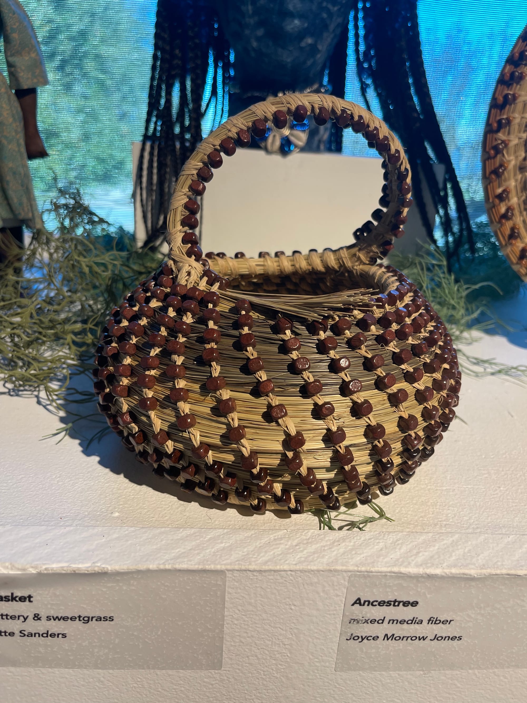 brown, woven round basket with a semi-circular handle