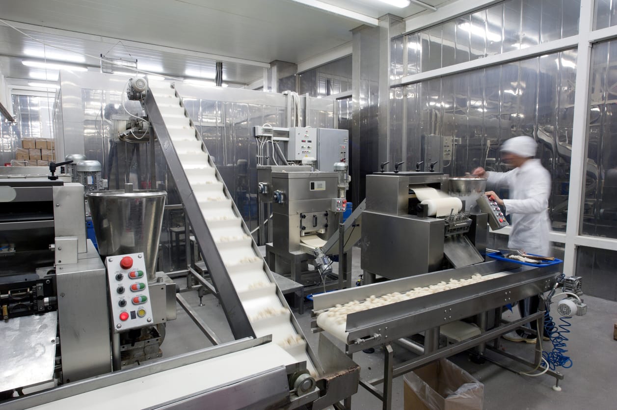 Automated production line in modern food factory. People working.