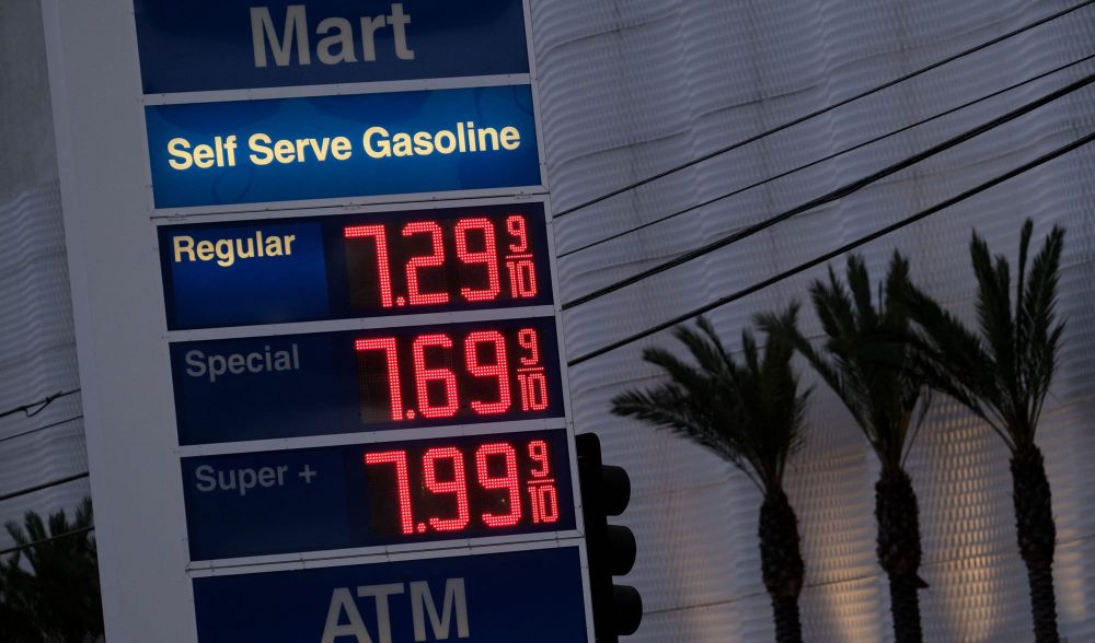 gas station sign shows prices at $7.29, $7.699, and $7.99 per gallon